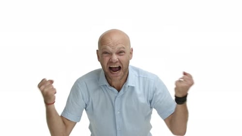 Middleaged Bald Man with Beard Wearing Blue Shirt Cross Arms Chest and Looking Pissedoff Starting to