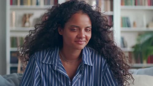 Smiling Woman With Curly Hair in Home Setting
