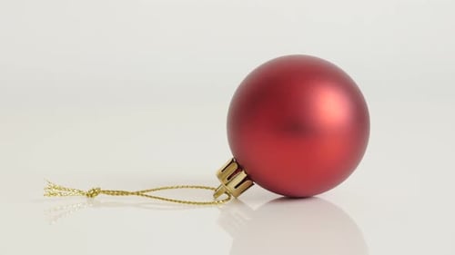 Tilting on matte color shiny bauble close-up 4K 2160p 30fps UltraHD footage - Red Christams ornament