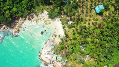 Paradise exotic beach hidden behind limestone cliffs washed by calm turquoise lagoon on tropical isl