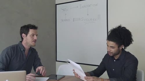 Young Adults Discussing Project in Modern Office