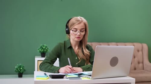 Young Woman Working on Laptop at Home
