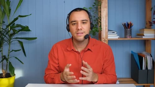 Young Adult Explains Concepts with Headset On