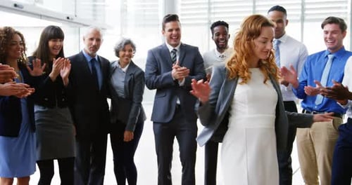 Enthusiastic Office Celebration for Successful Woman