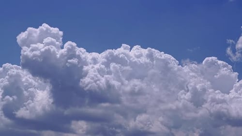 Puffy White Clouds Drifting in a Blue Sky