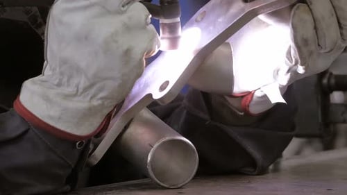 Welder Joining Metal Parts with Welding Torch