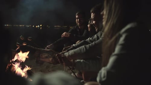 Friends Gather Round Beach Bonfire Roasting Marshmallows