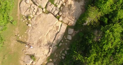 Aeriel Flyover a Couple Walking Through A Forest Park