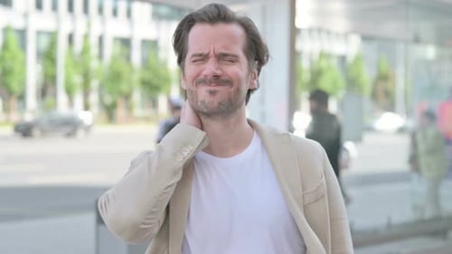 Man Suffering Neck Pain in an Urban Setting