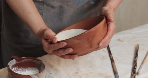 Skilled Potter Glaze Covers the Cup From Red Clay. Close Up. Process. Ceramic Workshop.