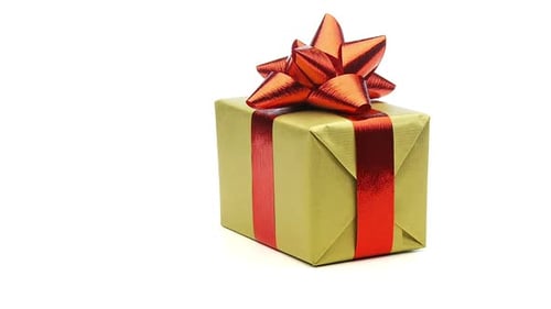 Gold Wrapped Gift with Red Bow on White
