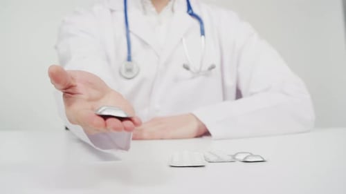 Doctor giving a blister with pills