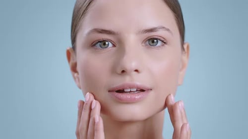 Young Woman Applies Skincare in Extreme Close Up