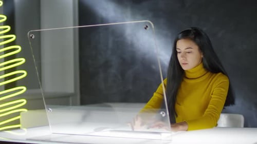 Young Woman Coding on Futuristic Computer