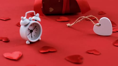 Clock with Heart and Gift on Red Background