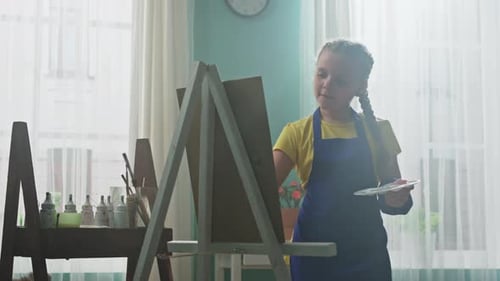 Young Child Painting in a Bright Art Studio