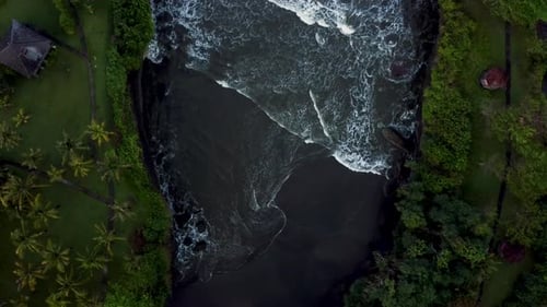 Top down view on lagoon with black sand