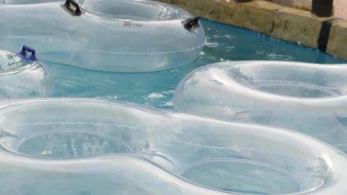 Close Up of White Transparent Floaters Moving with the Current in Lazy River