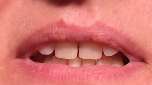 Person's Lips and Teeth in Extreme Close Up