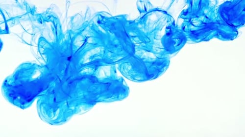 Blue Ink Swirling Gracefully in White Water