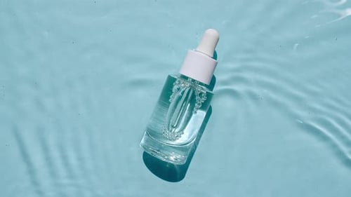 Bottle of Clear Liquid With Rippling Water