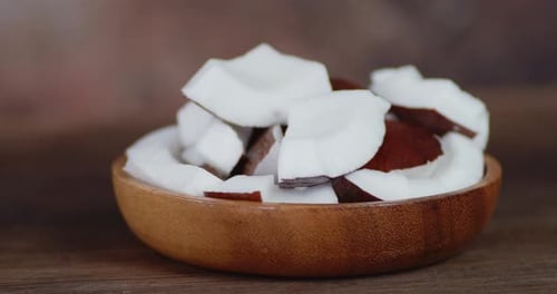 Close Up of Coconut Chunks in Wooden Bowl