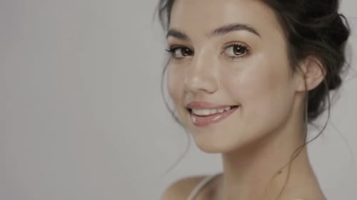 Close-up Portrait of Beautiful Woman with Light Make-up and Glossy Lips