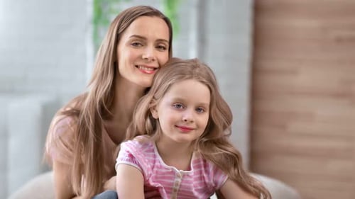 Loving Mother and Daughter Posing Indoors