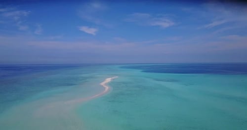 Wide angle birds eye island view of a white paradise beach and aqua blue ocean background in hi res