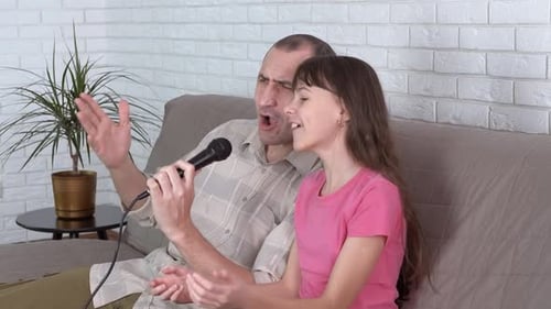 Father and Child Singing Karaoke at Home