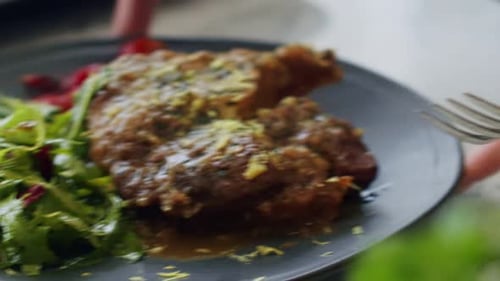 Juicy Meat Served with Salad Being Cut