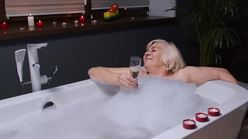 Woman Relaxing in a Bubble Bath with Champagne