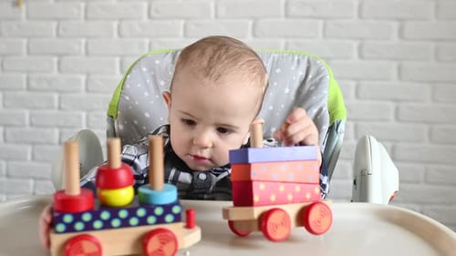 Adorable Baby Playing with Colorful Wooden Toy Trains