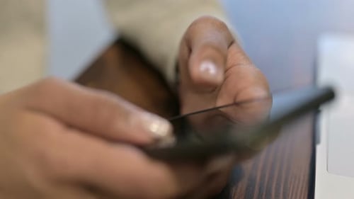 Close Up of African Woman Hands Text Messaging on Smartphone