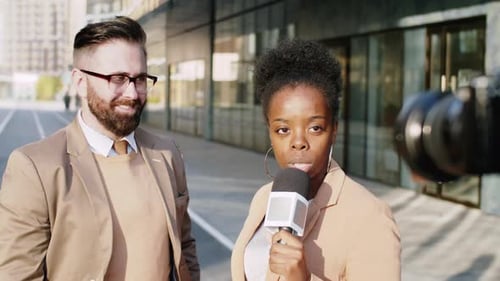Reporter Interviewing Man in Urban Setting