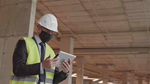 Foreman Wearing Mask Posing in Building