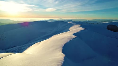Snowy Mountain Peaks at Sunrise Aerial View