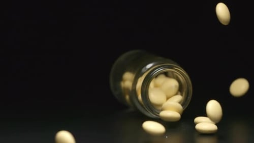 Glass jar falls and yellow pills fall out of him
