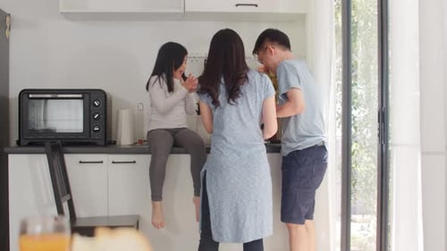 Family Preparing Food Together in Bright Kitchen
