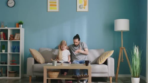 Father Reading with his Daughter on the Sofa