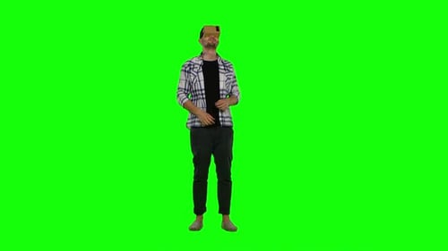 Young Man Trying Virtual Reality Glasses - VR Glasses - and Exploring Virtual Reality. Green Screen