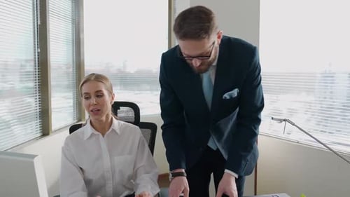 Businesswoman Working in Office with Man in Suit