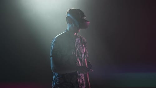 Man Using VR Headset and Controllers in Studio