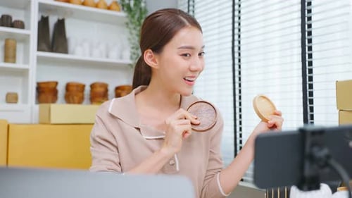 Asian beautiful woman sell vase product online live streaming at home.