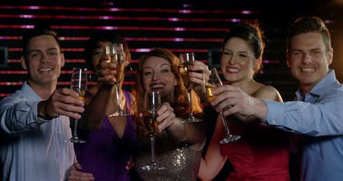 Happy Friends Toasting with Champagne in a Nightclub
