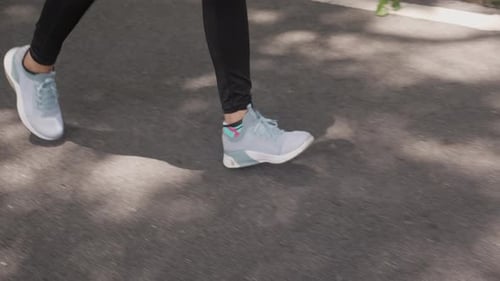 Closeup leg and foot of woman workout with jogging or running on summer in the park.