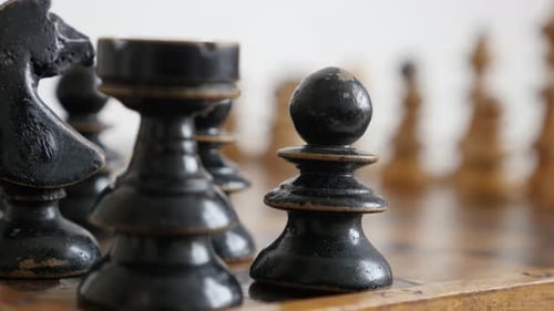 Old chess set figures arranged on playing table close-up 4K 2160p 30fps UltraHD footage - Wooden bl