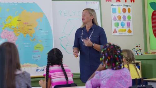 Teacher in school classroom giving lesson