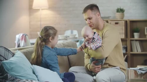 Father and Children on the Couch at Home