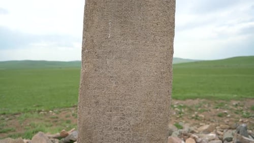 Ancient Stone Pillar Standing in Grassy Field